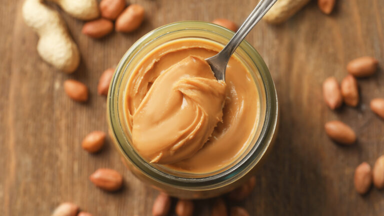 Spoon,And,Glass,Jar,With,Creamy,Peanut,Butter,On,Kitchen